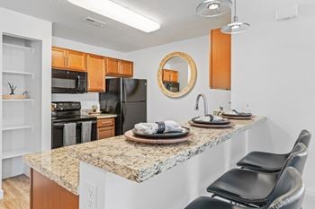 Kitchen with counter and bar stools